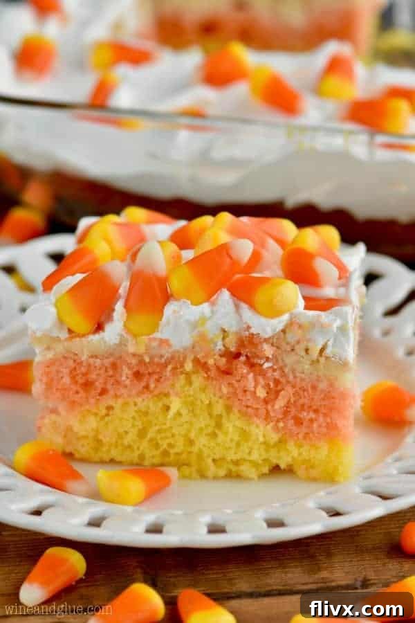 Colorful Candy Corn Poke Cake with distinct layers