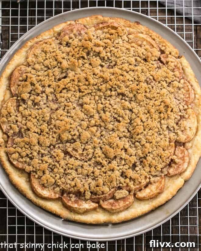 Overhead view of Apple Pie Pizza baked on a pizza pan, showcasing its golden crust and crumbly topping.
