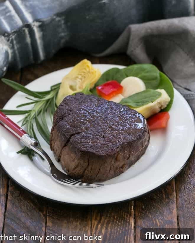 Uncut Filet Mignon steak generously coated with a rich Red Wine Balsamic Sauce, ready to be served.