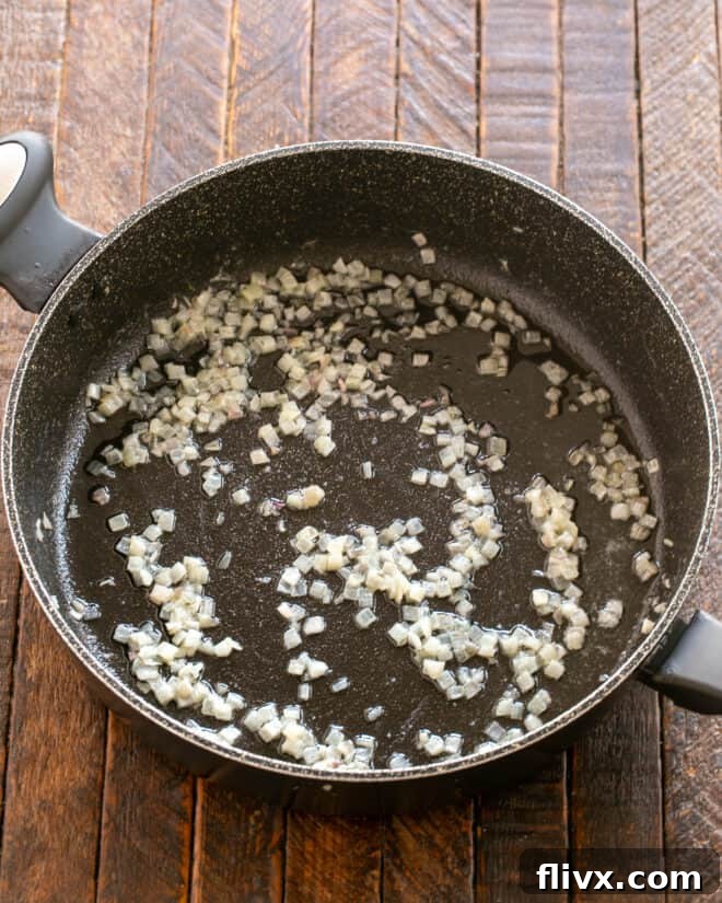Step 2: Remove seared filets from the pan, then add butter and sauté minced shallots until softened and translucent.