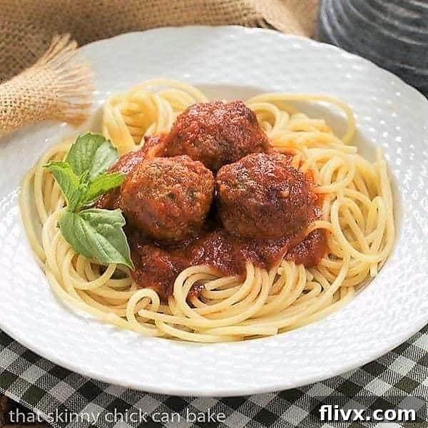Classic Italian Meat Sauce in white bowl garnished with basil.