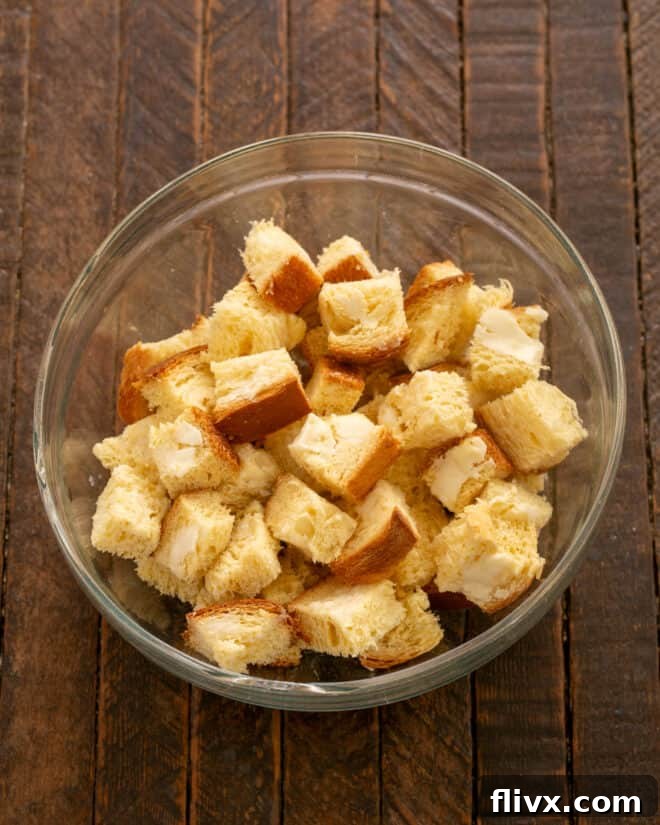 Butter slices of bread and cut into cubes for the soufflé base.