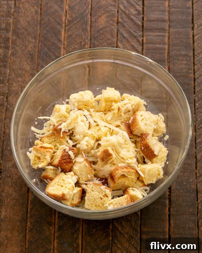 Gently toss the bread, milk, cheese, salt, and pepper mixture until well combined.