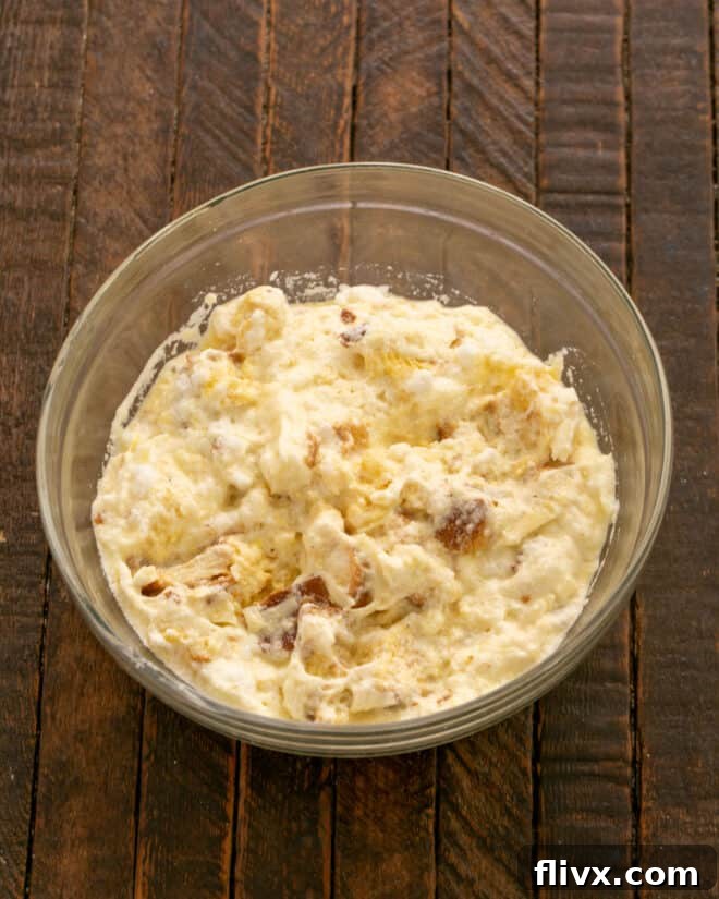 Stir whipped egg yolks into the bread mixture, then gently fold in the stiff egg whites.