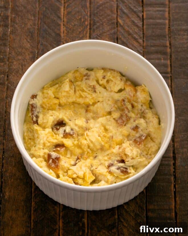 Scrape the cheese soufflé mixture into a prepared buttered casserole dish.