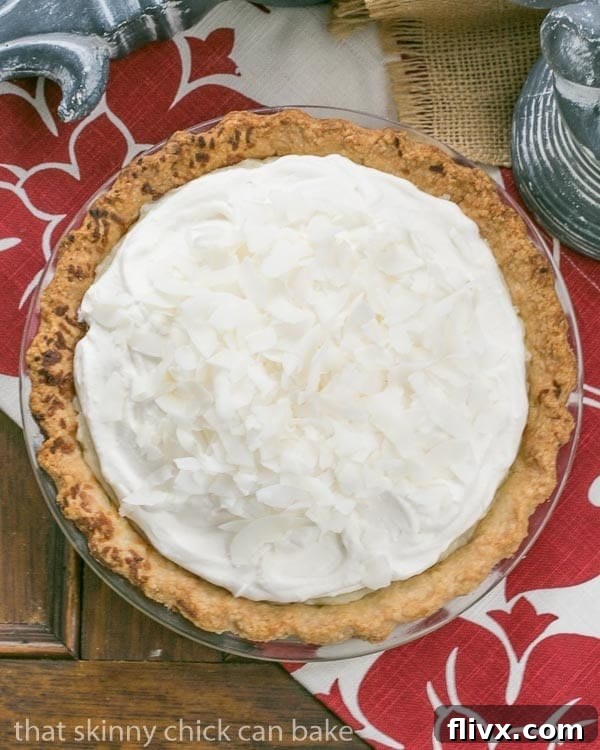 Close-up of a Coconut Cream Pie slice, showcasing the creamy filling and golden crust. An irresistible dessert.