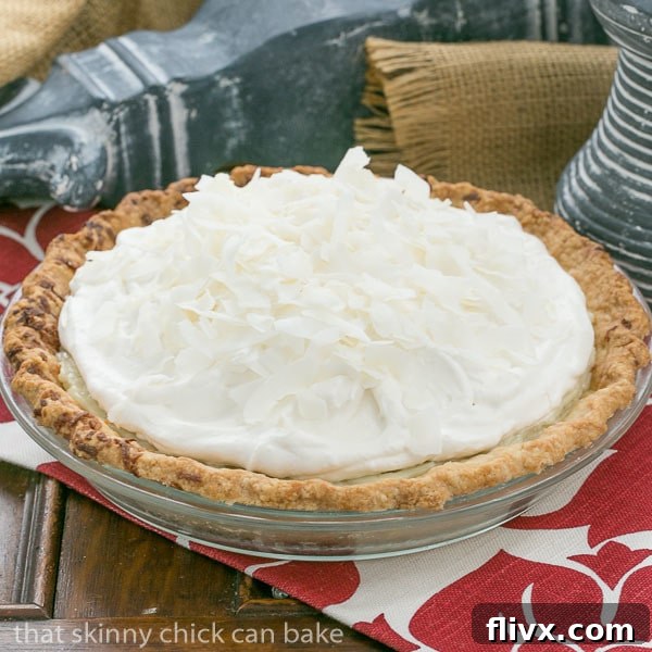 Full view of a stunning Coconut Cream Pie, ready to be served. A tropical delight for any occasion.