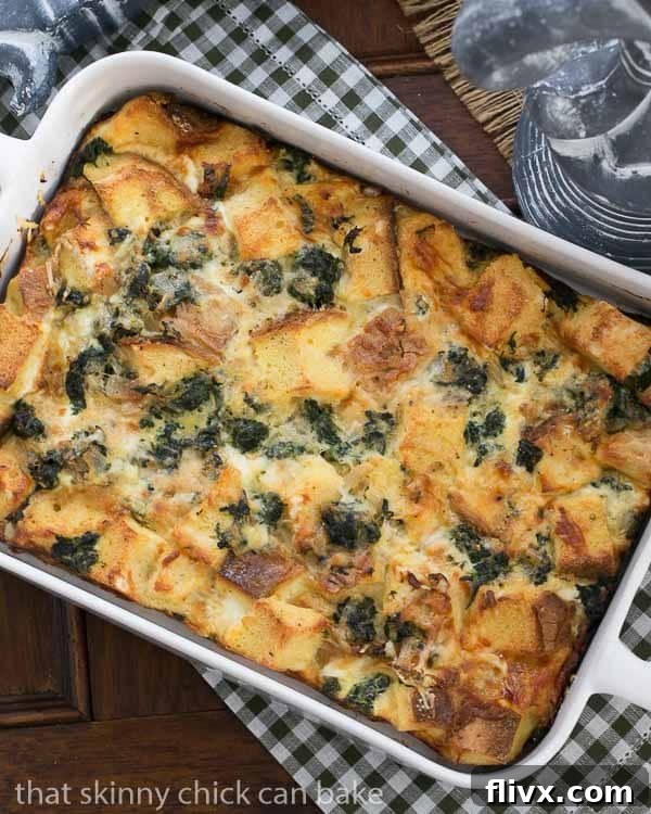 Gruyere Spinach Strata in a white casserole dish.