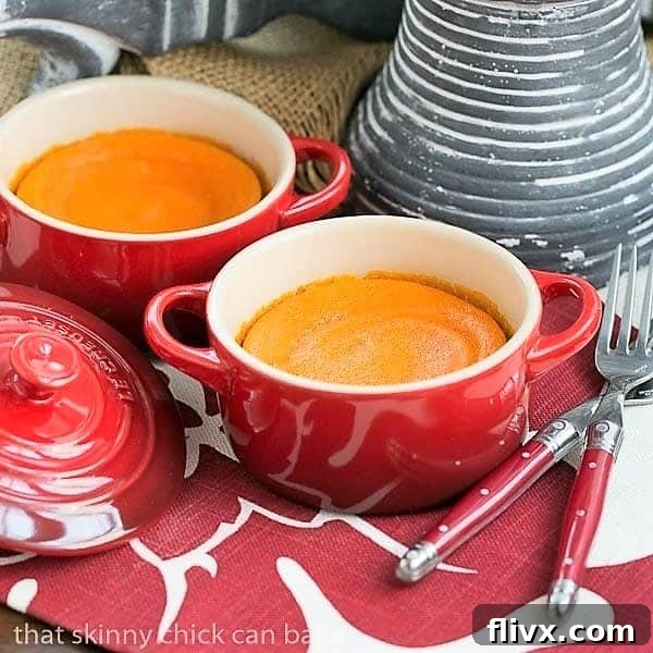 Two small red terrines filled with golden Carrot Puff, ready to be served. Ideal for individual portions on a holiday table.