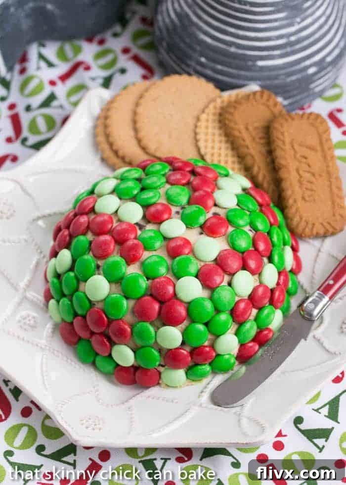 Overhead shot of a delicious Cookie Dough Cheese Ball on a white geometric plate, perfect for serving