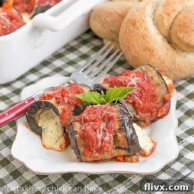 Eggplant Rollatini on a white dish with a red handled fork
