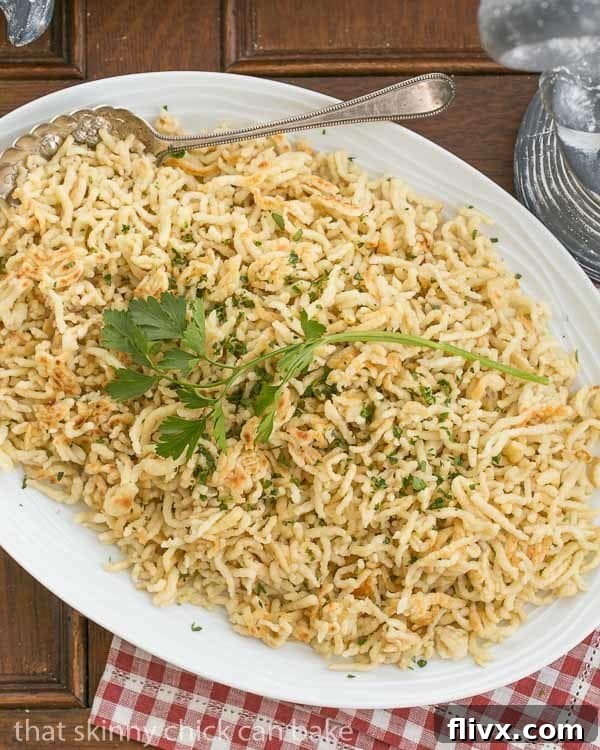 An abundant platter filled with freshly prepared, golden-brown homemade spaetzle, showcasing its inviting texture and readiness to be served as a delicious and comforting dish.