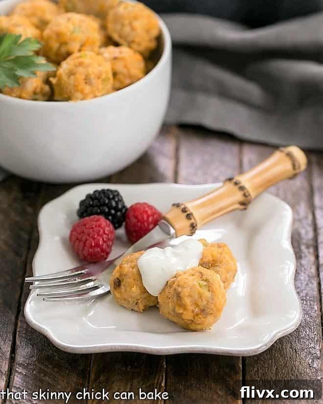 Buffalo chicken meatballs and berries on a white appetizer plate