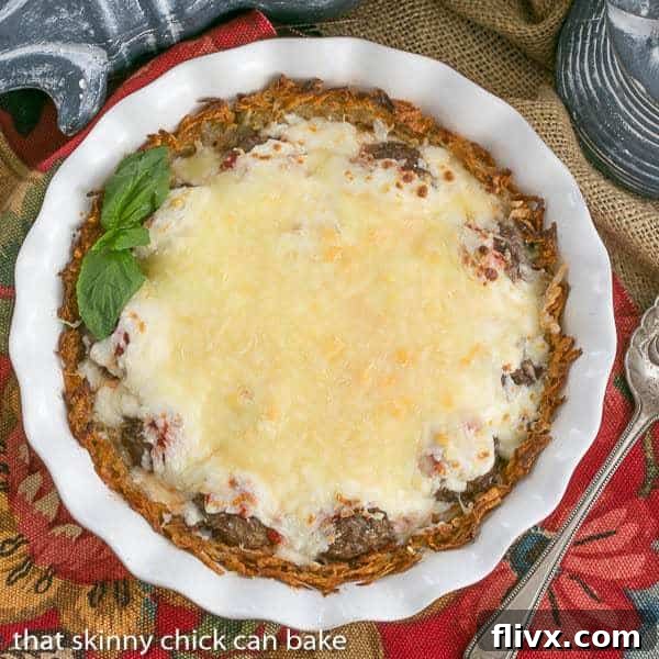 Italian Poutine Pie | A savory pie with a hash brown crust, marinara, meatballs and gooey mozzarella