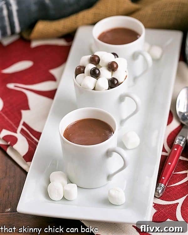 Two mugs of Italian Hot Chocolate on a white tray, ready to be enjoyed.