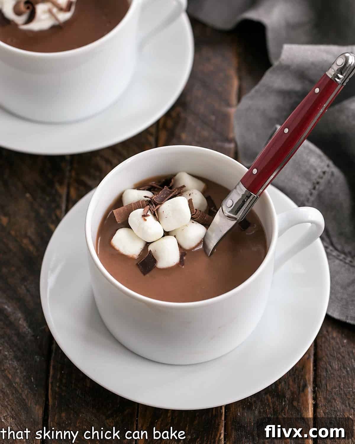 Thick Italian hot chocolate in a white coffee cup with a red handle spoon inserted, ready for a decadent dessert.
