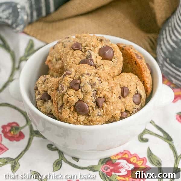 A bowl full of freshly baked Oatmeal Chocolate Chip Cookies, showcasing their golden-brown edges and melty chocolate chips.