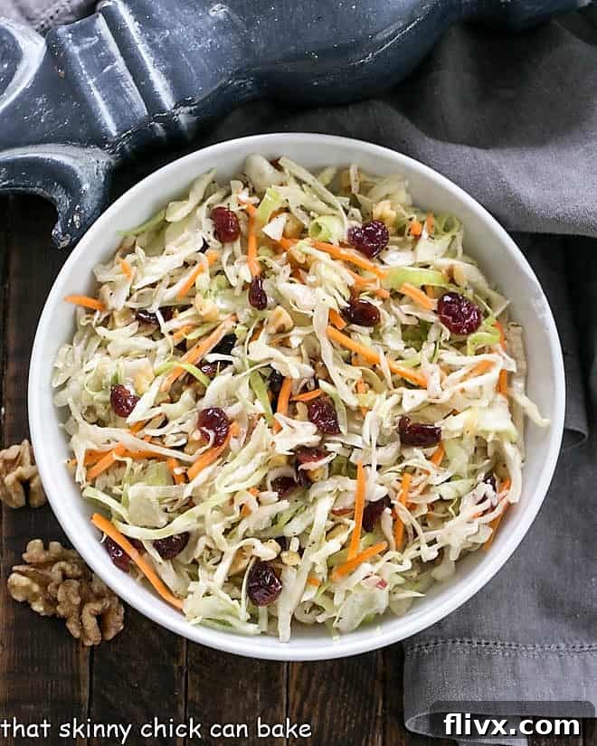 Overhead view of Easy Coleslaw in a white serving bowl, showcasing its fresh ingredients and inviting texture.