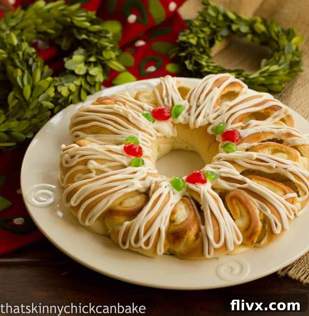 Holiday Cream Cheese Tea Roll on a white plate with festive decorations