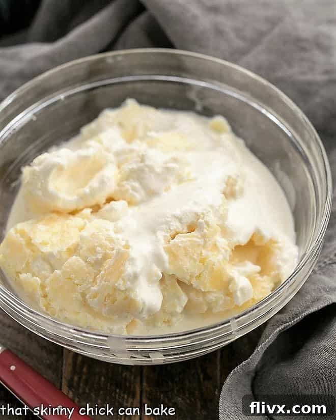 A bowl of freshly made homemade clotted cream, creamy and golden, scooped directly from the Instant Pot and ready to be served with your favorite British treats.