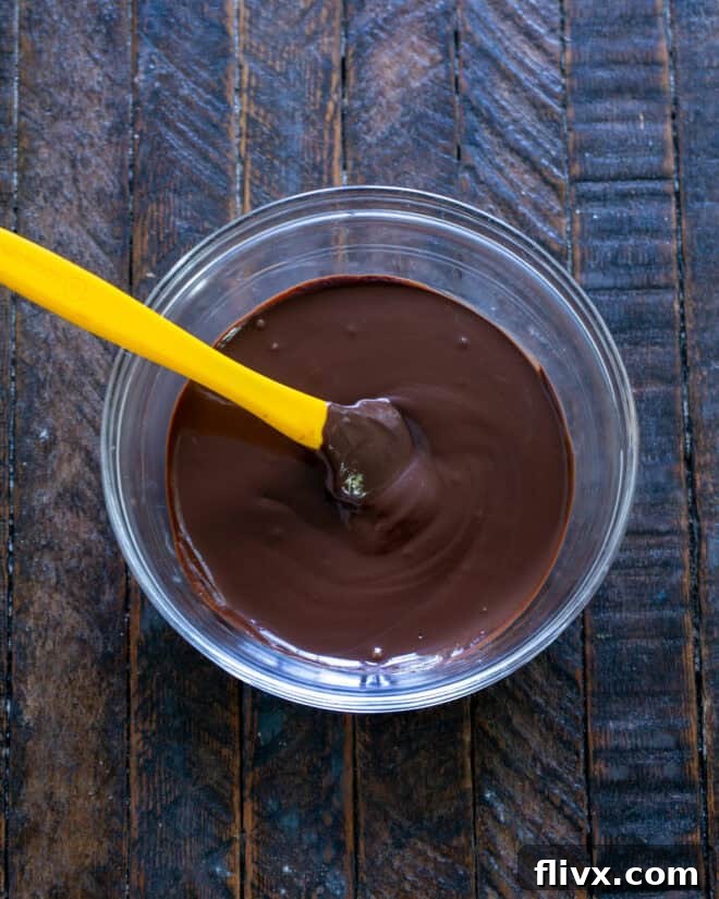 Butter and chocolate gently melting in a bowl, preparing for the brownie cookie dough.