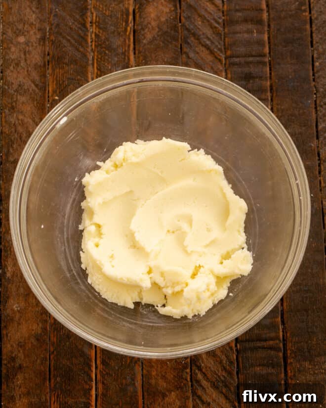 Creaming butter and sugar together in a mixing bowl until light and fluffy.