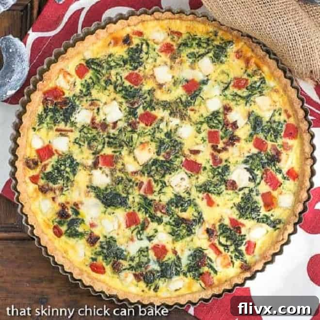 An overhead view of the golden brown Sun-dried Tomato and Spinach Quiche, showcasing its delicious texture and vibrant fillings.