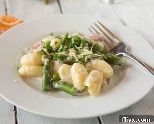 Comforting Creamy Spring Gnocchi with ham and fresh asparagus.