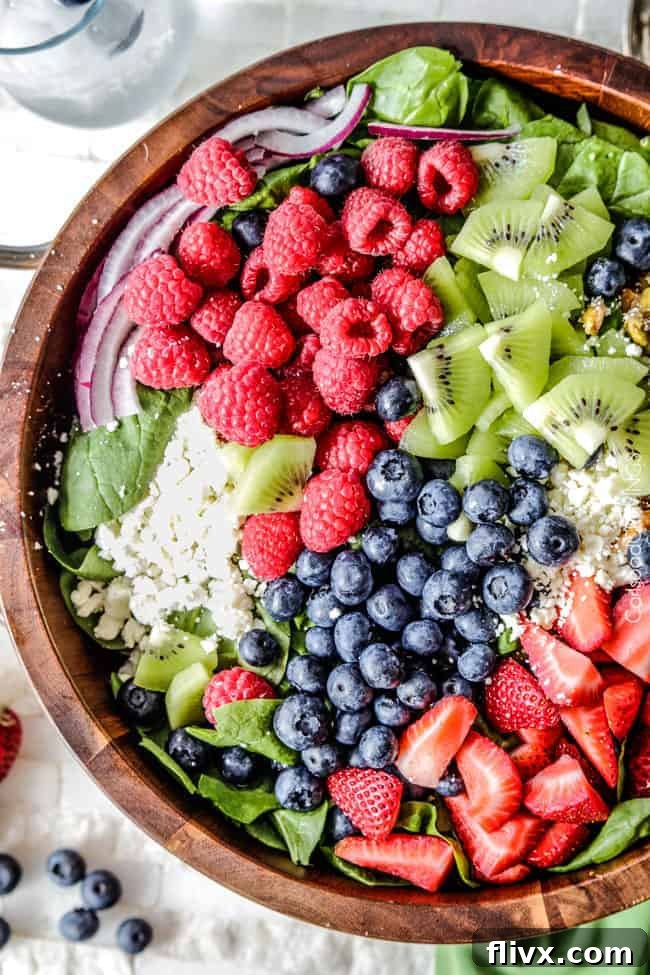 Vibrant Spinach Berry Salad with feta cheese and creamy strawberry poppy seed dressing.