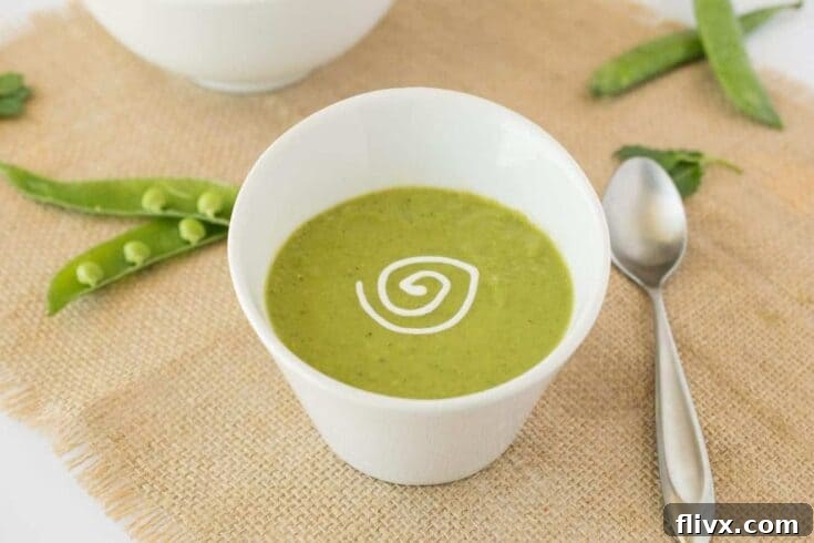 Smooth and creamy Spring Pea and Mint Soup, garnished with fresh herbs.