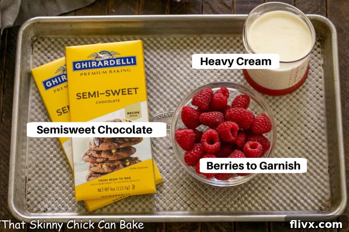 The Dark Nemesis 3 La Bete Noire ganache and garnish ingredients arranged on a sheet pan with labels, including heavy cream, chocolate, fresh berries, and whipped cream, prepared for the final touches.
