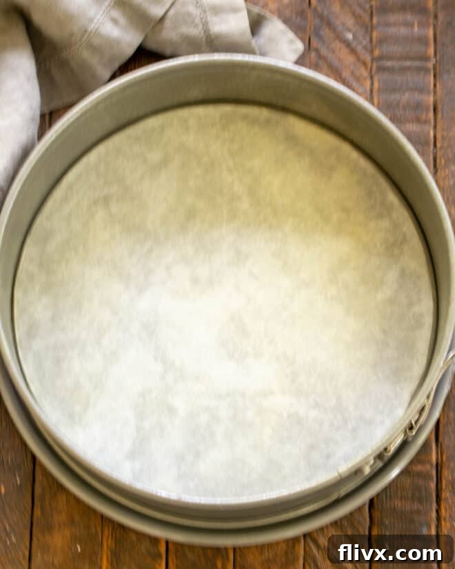 The Dark Nemesis 4 Step 1: Preparing a springform pan for La Bete Noire by buttering and lining with parchment paper.