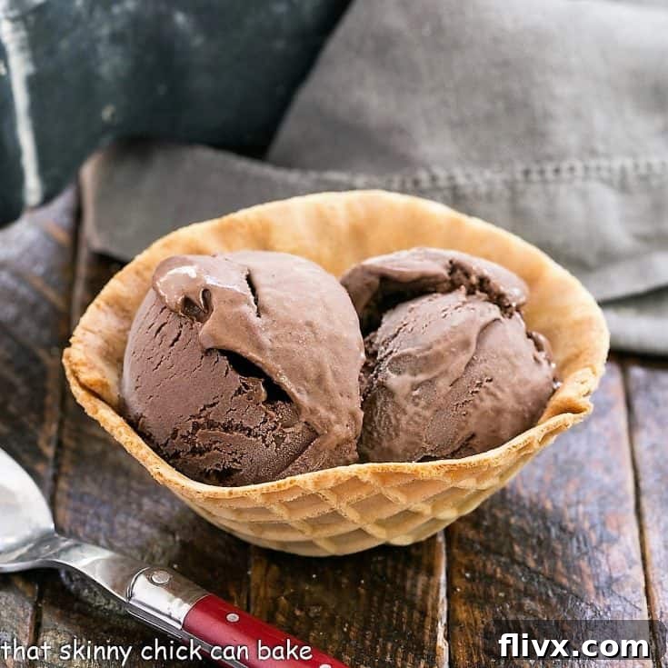 Scoops of rich chocolate ice cream nestled in a golden waffle cone bowl, ready for enjoyment.