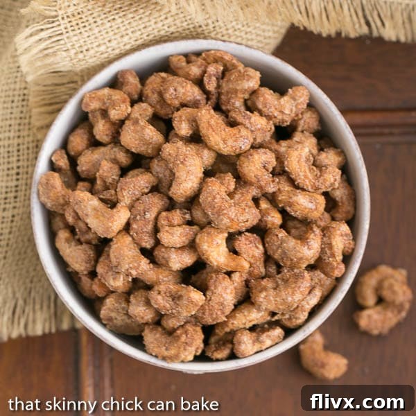 A close-up, top view of a bowl of Spicy Sugared Cashews, highlighting their glossy, spiced coating.