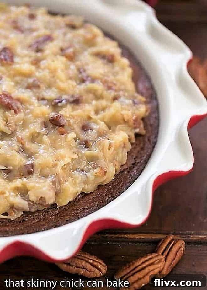 A stunning German Chocolate Brownie Pie presented in an elegant ruffle-edged pie plate, garnished with whole pecan halves.