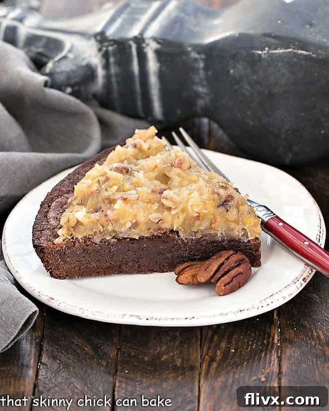 A beautifully cut slice of German Chocolate Brownie Pie, artfully placed on a round white plate with a red-handled fork, inviting enjoyment.