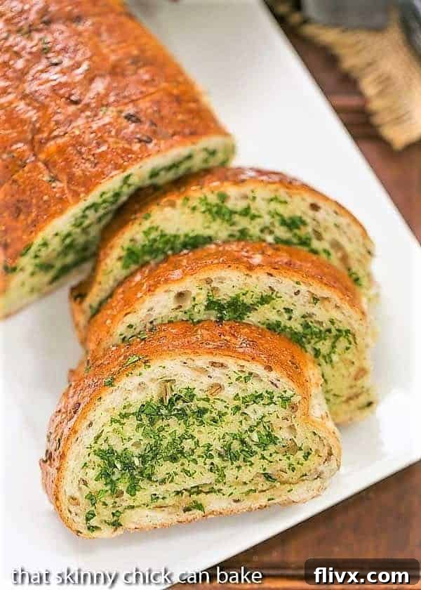  Overhead view of slices of Herb Garlic Bread on a white platter