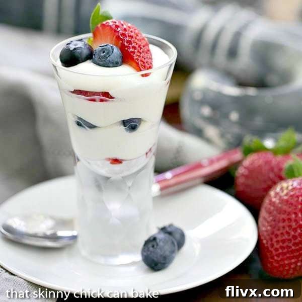 White Chocolate Berry Parfaits on a small plate with blueberries and strawberries to garnish