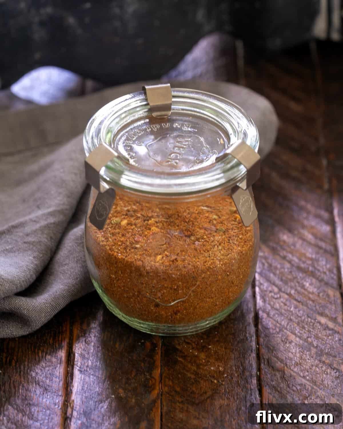Taco seasoning in a clear glass storage container, ready for use.