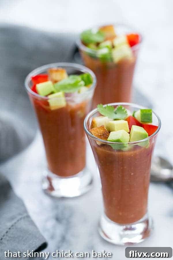 Elegant Gazpacho Shooters arranged on a sleek marble tray, ready to be served as sophisticated appetizers.