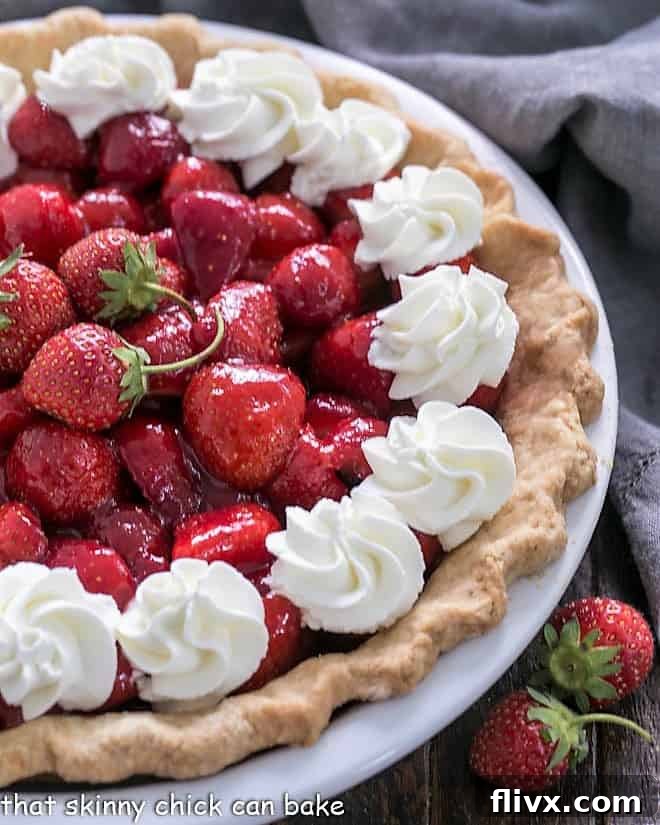 A classic Fresh Strawberry Pie, brimming with whole, ripe strawberries in a flaky crust.