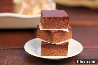 Fudgy truffle brownies topped with chocolate ganache, ready to be served.