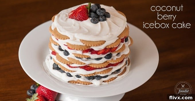 A slice of no-bake coconut berry icebox cake, showing layers of cream, coconut, and berries.