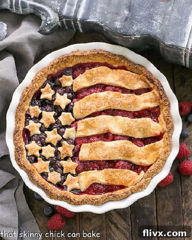 A patriotic stars and stripes berry pie, with a beautifully crafted crust.