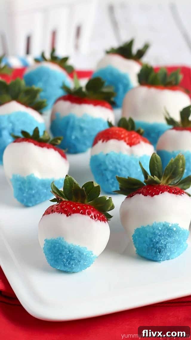 Fresh strawberries dipped in white chocolate and decorated with blue sprinkles.
