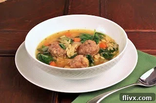 A bowl of Italian Wedding Soup, perfect for a cozy autumn or winter meal, with its rich broth, tender meatballs, and fresh greens.