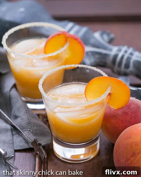 Two Fresh Peach Margaritas in highball glasses, garnished with lime slices.
