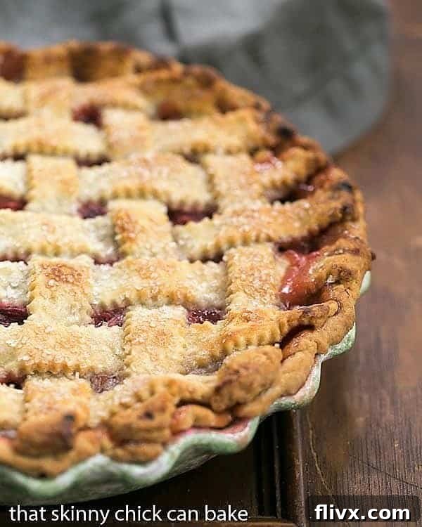 A stunning Classic Rhubarb Pie nestled in its ceramic pie plate, ready to be sliced and enjoyed.