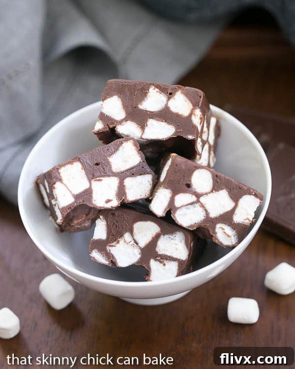 Overhead view of Chocolate Marshmallow Fudge squares in a white bowl, ready to be served.