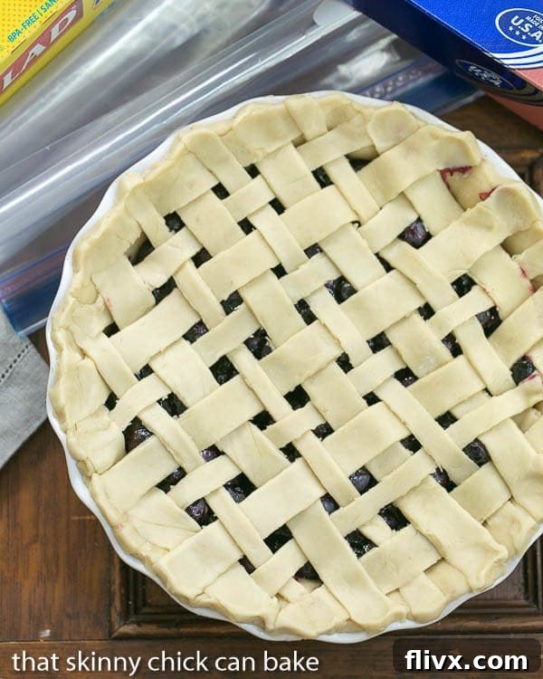 An unbaked Freeze and Bake Blueberry Pie, showcasing a beautifully crafted lattice crust from a top-down view, ready for its journey to the freezer.